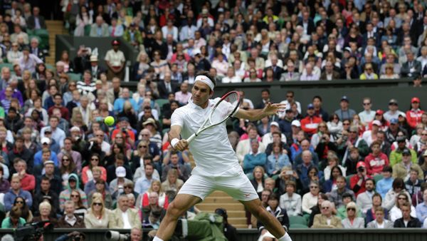 Roger Federer of Switzerland volleys a return to Victor Hanescu of Romania during their Men's first round singles match at the All England Lawn Tennis Championships in Wimbledon, London, Monday, June 24, 2013. - Sputnik International