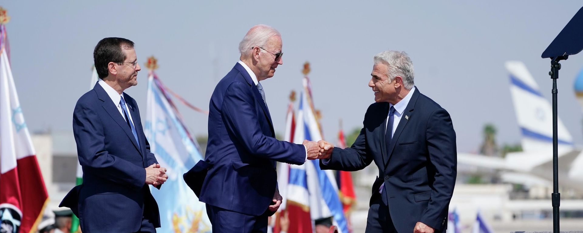 President Joe Biden is greeted by Israeli Prime Minister Yair Lapid, right and President Isaac Herzog, left, as they participate in an arrival ceremony after Biden arrived at Ben Gurion Airport, Wednesday, July 13, 2022, in Tel Aviv. President Joe Biden is greeted by Israeli Prime Minister Yair Lapid, right and President Isaac Herzog, left, as they participate in an arrival ceremony after Biden arrived at Ben Gurion Airport, Wednesday, July 13, 2022, in Tel Aviv. - Sputnik International, 1920, 27.10.2022
