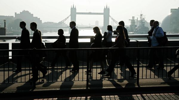 City workers walk across London Bridge, back dropped by Tower Bridge over the River Thames,  as they walk towards their offices in the financial centre in the City of London, Thursday, Sept. 18, 2008 - Sputnik International