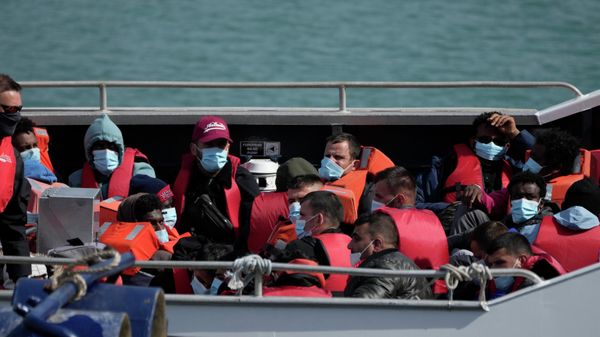 Illegal immigrants trafficked from France in small boats and were picked up in the Channel, wait to be disembarked from a British border force vessel in Dover - Sputnik International