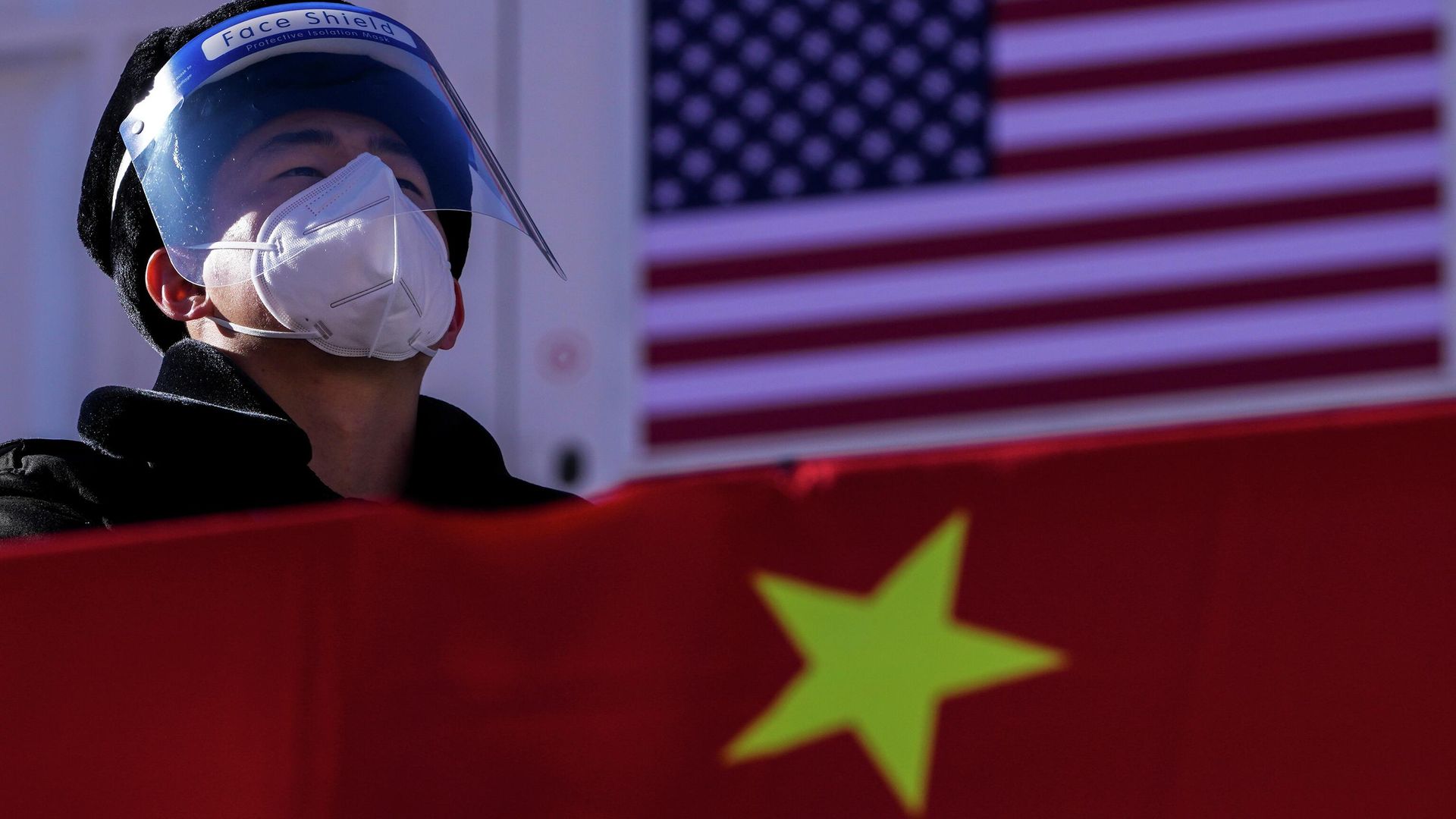 A security personnel wearing a face shield and a mask to help protect from the coronavirus stands watch at the Alpine downhill venue displaying the China and United States national flags A security personnel wearing a face shield and a mask to help protect from the coronavirus stands watch at the Alpine downhill venue displaying the China and United States national flags - Sputnik International, 1920, 15.12.2022