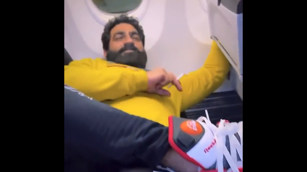 Screenshot from a viral video showing a passenger smoking a cigarette in a SpiceJet aircraft - Sputnik International