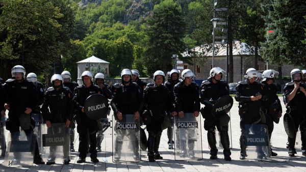 Police officers are seen in riot control gear while citizens of Montenegrin town of Cetinje gather at a baricade near the entrance of the city, on September 4, 2021, to protest against the enthronement of the new bishop of the Serbian Orthodox Church in Montenegro.  - Sputnik International