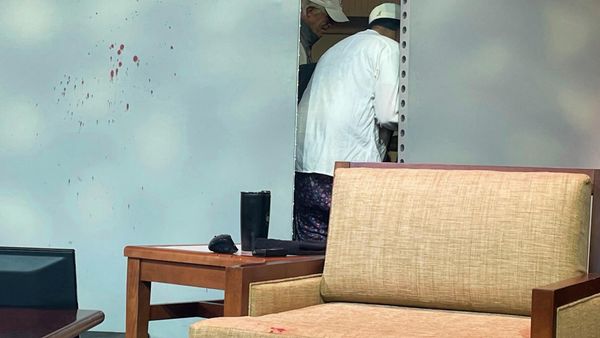 Blood stains mark a screen as author Salman Rushdie, behind screen, is tended to after he was attacked during a lecture, Friday, Aug. 12, 2022, at the Chautauqua Institution in Chautauqua, N.Y. - Sputnik International