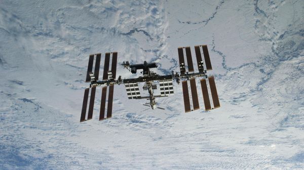 In this photo provided by NASA, backdropped against clouds over Earth, the International Space Station is seen from Space Shuttle Discovery as the two orbital spacecraft accomplish their relative separation on March 7, 2011 - Sputnik International