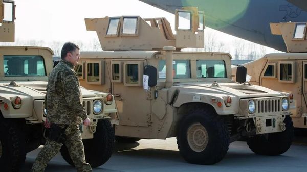 Ukrainian President Petro Poroshenko inspects HMMWV vehicles during a ceremony to welcome a US Air Force aircraft with the first batch of American armored vehicles at Borispol International Airport in 2015. - Sputnik International