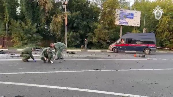 Investigators working at the scene of the car accident that killed Russian journalist and political analyst Daria Dugina. Moscow region, August 21, 2022 - Sputnik International