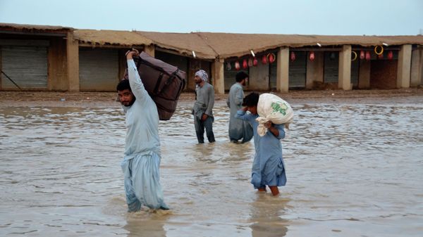 People navigate through a flooded road caused by heavy monsoon rains, in Nasirabad, a district of Pakistan's southwestern Baluchistan province, Monday, Aug. 22, 2022. - Sputnik International