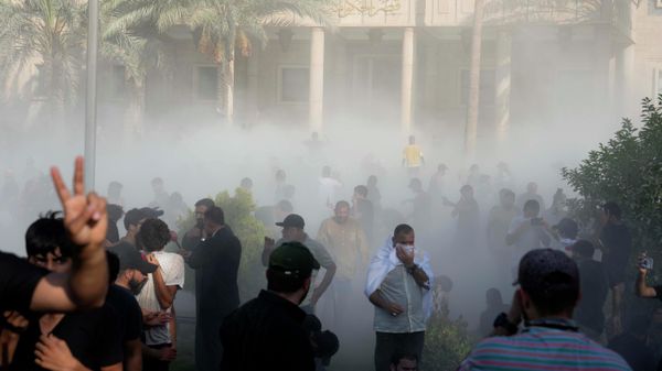 Iraqi security forces fire tear gas on followers of Shiite cleric Muqtada al-Sadr protesting inside the government palace grounds, in Baghdad, Iraq, Monday, Aug. 29, 2022 - Sputnik International