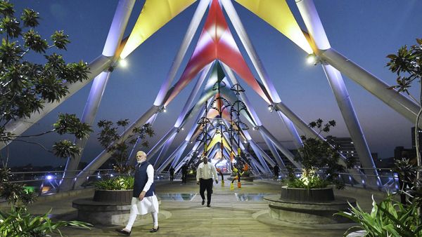 In this handout picture released by Gujarat Information Department and taken on August 27, 2022, India's Prime Minister Narendra Modi (L) walks during the inauguration of the pedestrian Atal Bridge over the Sabarmati River in Ahmedabad - Sputnik International