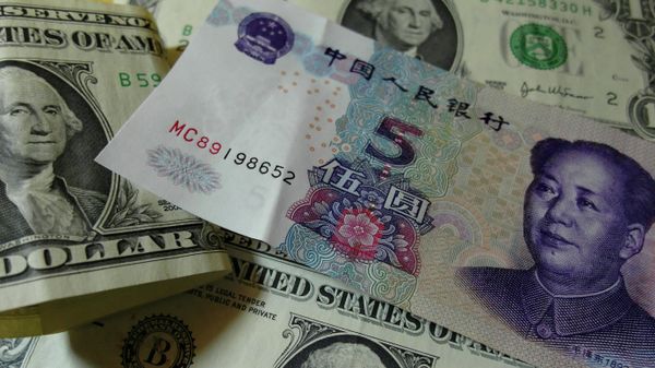 Yuan banknotes and US dollars are seen on a table in Yichang, central China's Hubei province on August 14, 2015 - Sputnik International
