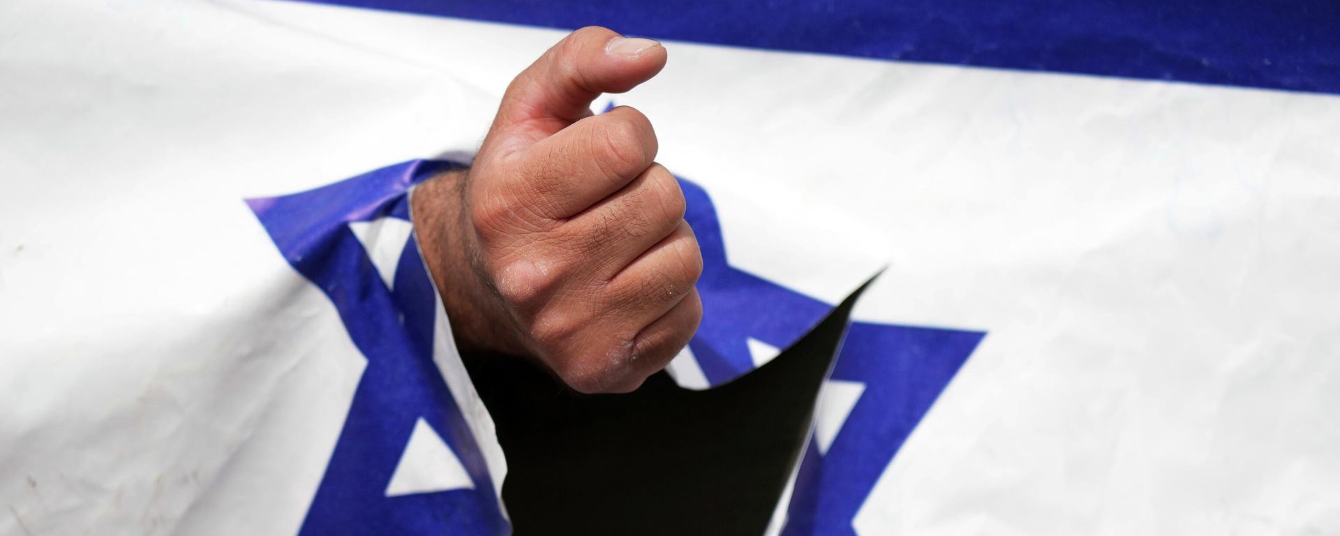 A demonstrator clenches his fist through a torn up representation of the Israeli flag in the annual pro-Palestinian Al-Quds, or Jerusalem, Day rally in Tehran, Iran, Friday, April 29, 2022 A demonstrator clenches his fist through a torn up representation of the Israeli flag in the annual pro-Palestinian Al-Quds, or Jerusalem, Day rally in Tehran, Iran, Friday, April 29, 2022 - Sputnik International, 1920, 05.09.2022