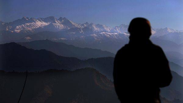 An Indian army soldier looks towards the snow-covered Pir Panjal range of mountains from one of their forward post at the Line of Control (LOC) between India and Pakistan border, in Poonch, about 248 kilometers (155 miles) from Jammu, India, Wednesday, Dec. 16, 2020 - Sputnik International