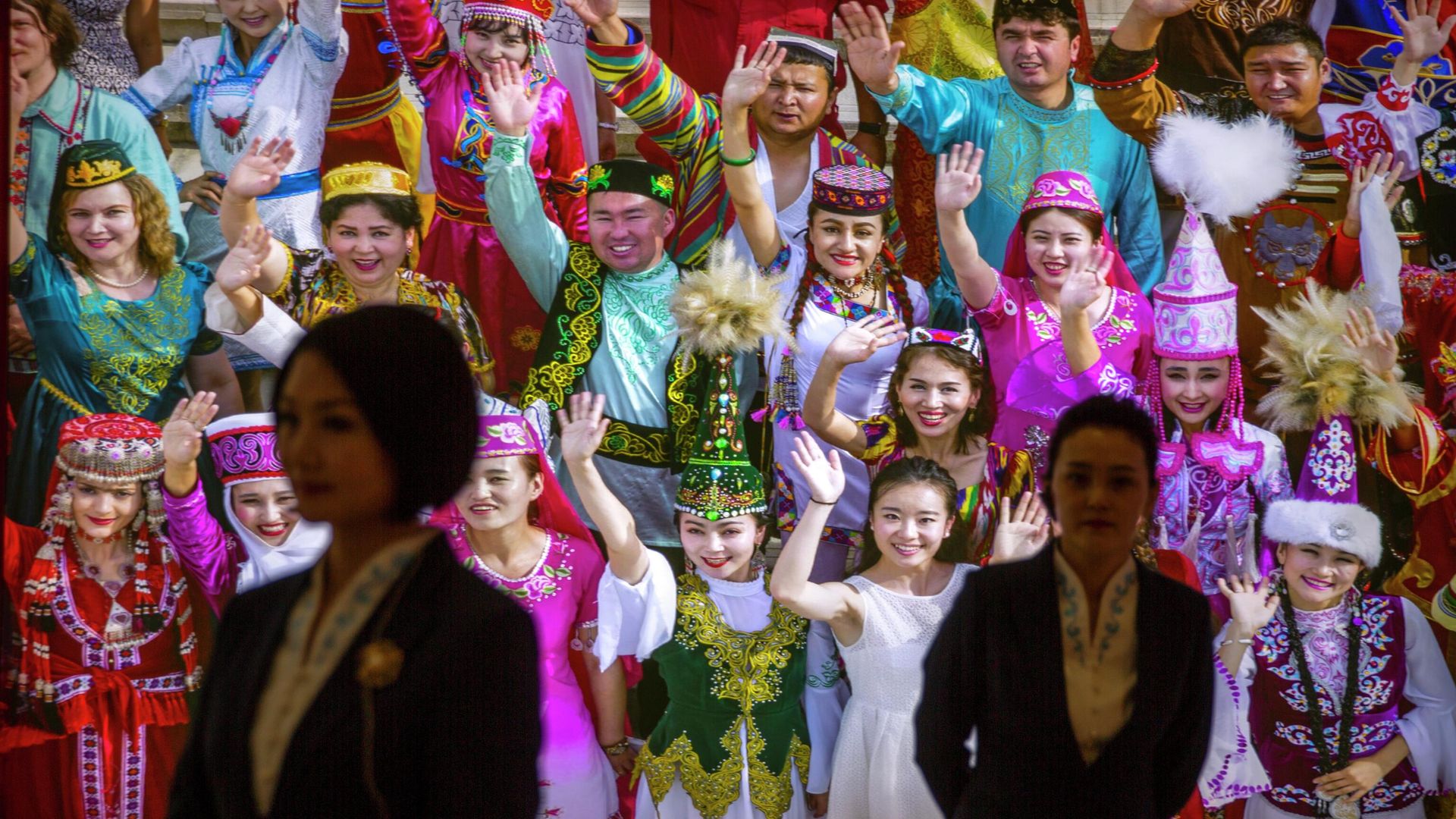 Tour guides stand in front of a large photo depicting different ethnic groups in Xinjiang at the Exhibition of the Fight Against Terrorism and Extremism in Urumqi in northwestern China's Xinjiang Uyghur Autonomous Region, as seen during a government organized visit, on April 21, 2021 Tour guides stand in front of a large photo depicting different ethnic groups in Xinjiang at the Exhibition of the Fight Against Terrorism and Extremism in Urumqi in northwestern China's Xinjiang Uyghur Autonomous Region, as seen during a government organized visit, on April 21, 2021 - Sputnik International, 1920, 08.09.2022