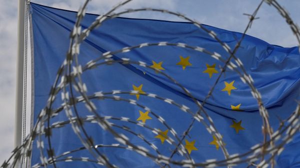  European Union flag waves behind barbwires - Sputnik International