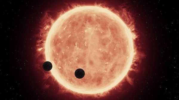 an artistic illustration of two exoplanets orbiting a red dwarf star An illustration of two rocky exoplanets transiting a red dwarf star - Sputnik International