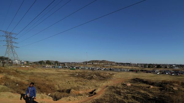 A man walks under the electricity power lines in Nomzamo Park, Soweto, Soweto, South Africa, Thursday, July 14, 2022. (AP Photo/Themba Hadebe) - Sputnik International