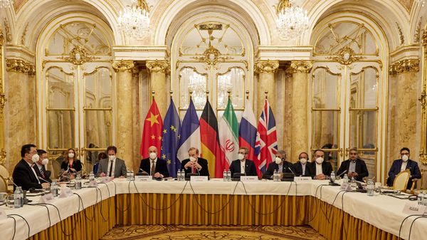 This handout photo taken and released on December 9, 2021 by the EU delegation in Vienna - EEAS shows representatives attending a meeting of the joint commission on negotiations aimed at reviving the Iran nuclear deal in Vienna, Austria. - Negotiators of the Iranian nuclear deal met on December 9, 2021, 'determined to work hard' to save the 2015 deal after the suspension of talks last week. (Photo by Handout / EU DELEGATION IN VIENNA / AFP)  - Sputnik International