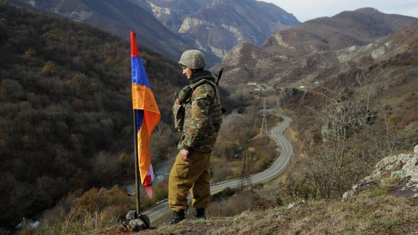 FILE - In this Wednesday, Nov. 25, 2020 file photo, An ethnic Armenian soldier stands guard next to Nagorno-Karabakh's flag atop of the hill near Charektar , Nov. 25, 2020 - Sputnik International