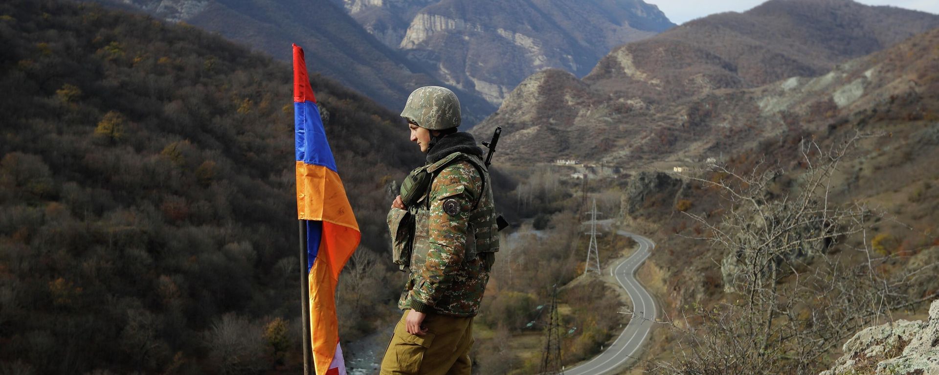FILE - In this Wednesday, Nov. 25, 2020 file photo, An ethnic Armenian soldier stands guard next to Nagorno-Karabakh's flag atop of the hill near Charektar , Nov. 25, 2020 FILE - In this Wednesday, Nov. 25, 2020 file photo, An ethnic Armenian soldier stands guard next to Nagorno-Karabakh's flag atop of the hill near Charektar , Nov. 25, 2020 - Sputnik International, 1920, 28.09.2023