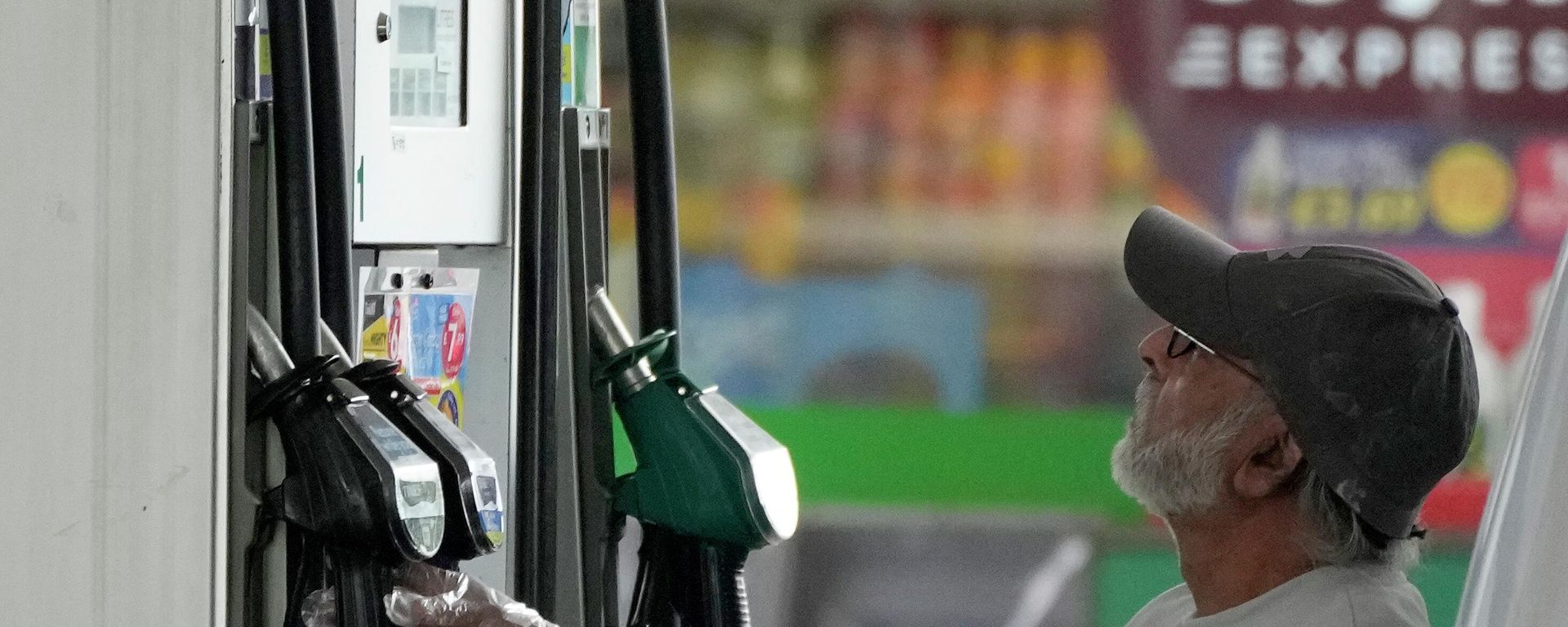 A driver looks at the petrol pump at a petrol station in London A driver looks at the petrol pump at a petrol station in London - Sputnik International, 1920, 14.09.2022