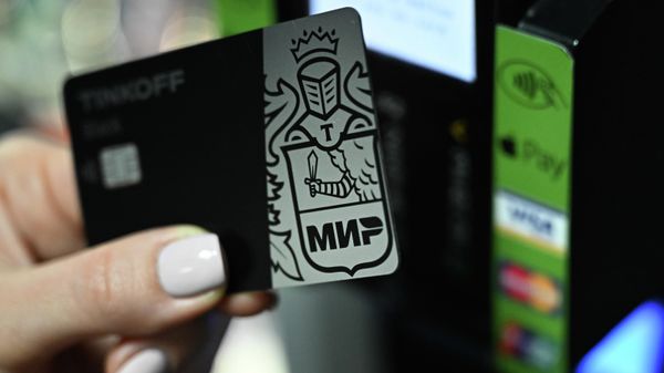 The girl pays with a card of the Russian national payment system Mir - Sputnik International