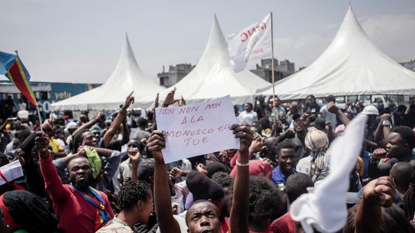 A man holds a placard during the burial of activists, who died during demonstrations that took place in Goma from July 25 to 27 to demand the departure of United Nations Organization Stabilization Mission in the Democratic Republic of the Congo (MONUSCO), in Goma on August 5, 2022. - Ten people who died in protests against the UN Mission that recently rocked towns in eastern Democratic Republic of Congo were laid to rest in Goma on August 5, 2022 after a popular tribute ceremony.
At the end of July, angry demonstrators ransacked and looted facilities of the United Nations Mission for the Stabilization of the DRC (Monusco), present in the country since 1999.
A total of 32 demonstrators and four peacekeepers were killed in a week of demonstrations in at least four eastern towns. (Photo by Guerchom Ndebo / AFP) - Sputnik International
