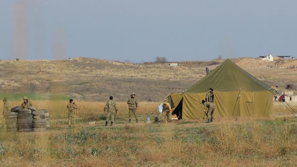 Azerbaijanian border gather at a tent as they control their side of the new border between the region of Nagorno-Karabakh and Azerbaijan, near the village of Berdashen, Tuesday, Nov. 24, 2020 - Sputnik International
