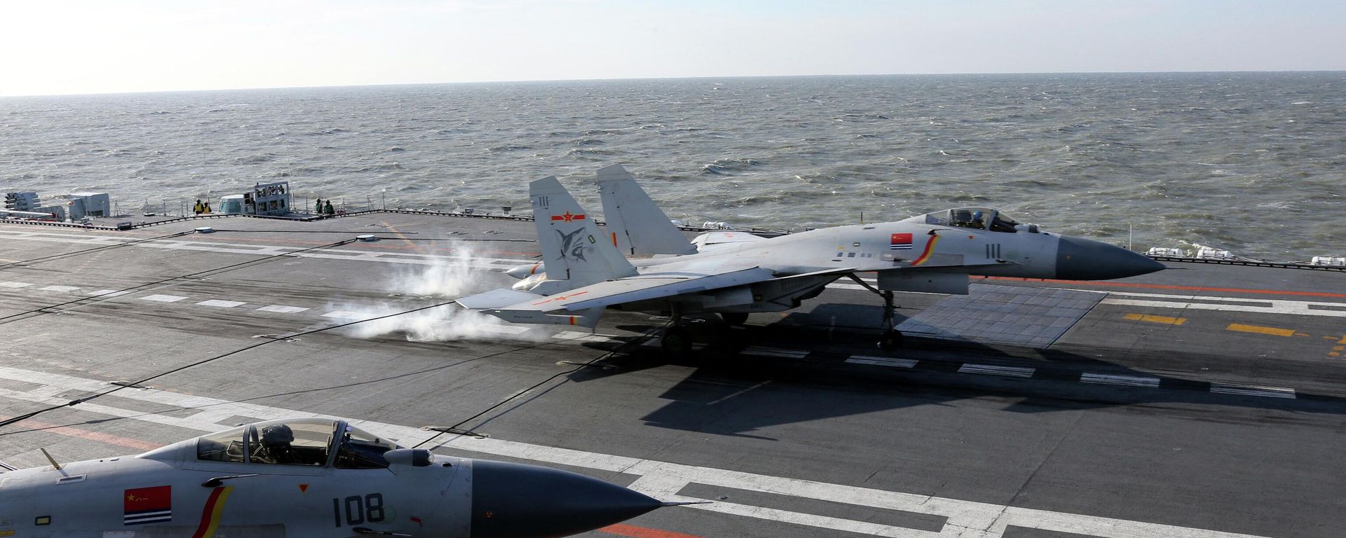 This picture taken on an undisclosed date in December 2016 shows a Chinese J-15 fighter jet landing on the deck of the Liaoning aircraft carrier during military drills in the Bohai Sea, off China's northeast coast This picture taken on an undisclosed date in December 2016 shows a Chinese J-15 fighter jet landing on the deck of the Liaoning aircraft carrier during military drills in the Bohai Sea, off China's northeast coast - Sputnik International, 1920, 02.10.2022