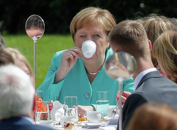 German Chancellor Angela Merkel drinks coffee as she attends a "coffee table" event hosted by the German President to celebrate the 70th anniversary of the Constitution (Grundgesetz) in the garden of the presidential residence Bellevue Palace in Berlin on 23 May 2019. - Sputnik International
