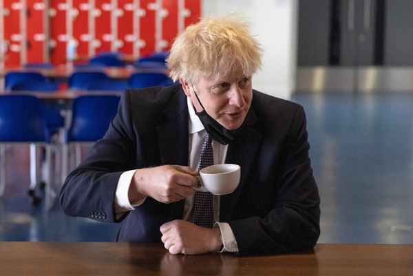Britain's Prime Minister Boris Johnson, holds a cup of coffee as he speaks with pupils after taking part in a science lesson at King Solomon Academy in London, on 29 April 2021. - Sputnik International