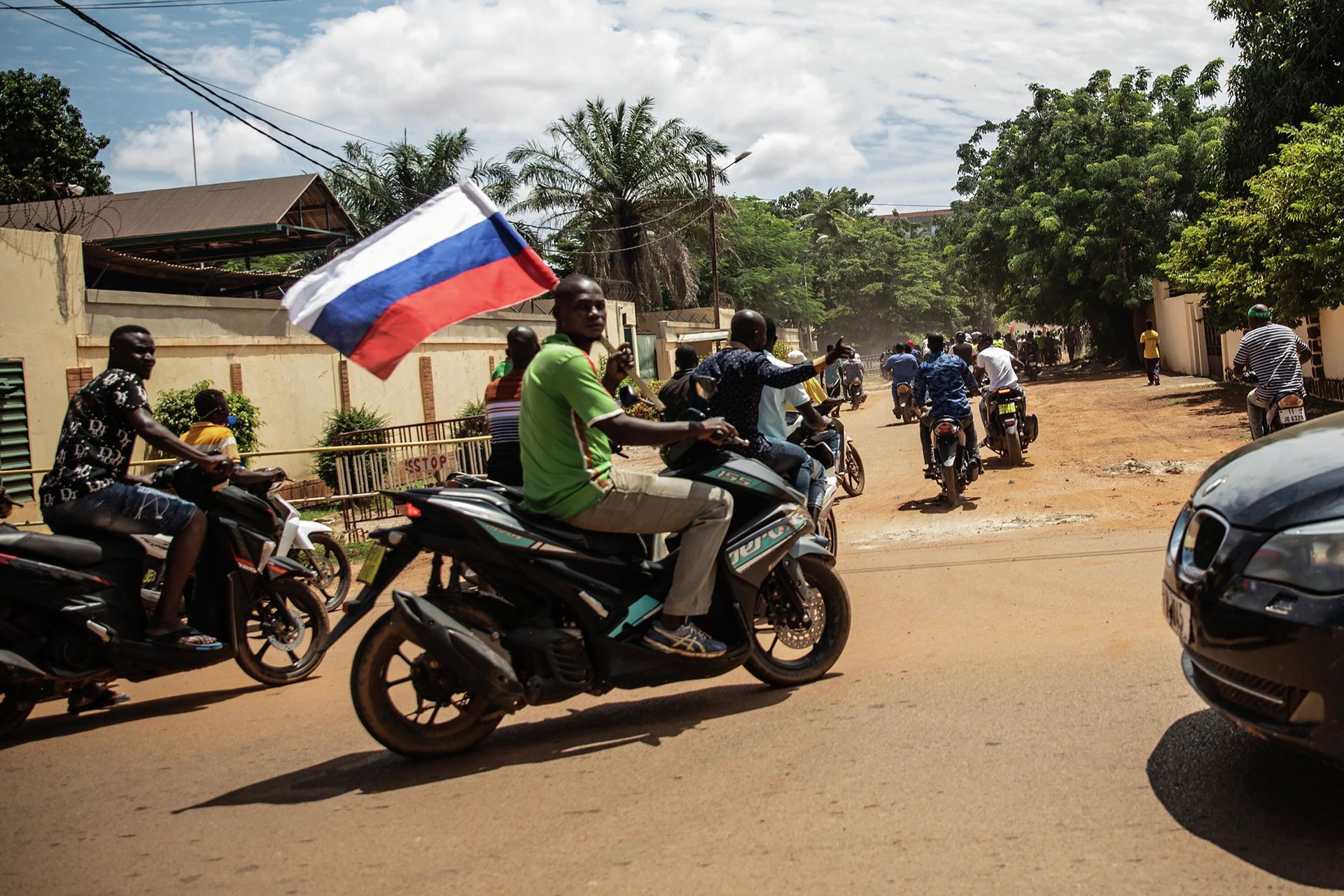 Supporters of Capt. Ibrahim Traore parade waving a Russian flag in the streets of Ouagadougou, Burkina Faso, Sunday, Oct. 2, 2022. Burkina Faso's new junta leadership is calling for calm after the French Embassy and other buildings were attacked. The unrest following the West African nation's second coup this year came after a junta statement alleged that the ousted interim president was at a French military base in Ouagadougou. France vehemently denied the claim and has urged its citizens to stay indoors amid rising anti-French sentiment in the streets. (AP Photo/Sophie Garcia) Supporters of Capt. Ibrahim Traore parade waving a Russian flag in the streets of Ouagadougou, Burkina Faso, Sunday, Oct. 2, 2022. Burkina Faso's new junta leadership is calling for calm after the French Embassy and other buildings were attacked. The unrest following the West African nation's second coup this year came after a junta statement alleged that the ousted interim president was at a French military base in Ouagadougou. France vehemently denied the claim and has urged its citizens to stay indoors amid rising anti-French sentiment in the streets. (AP Photo/Sophie Garcia) - Sputnik International, 1920, 15.10.2022