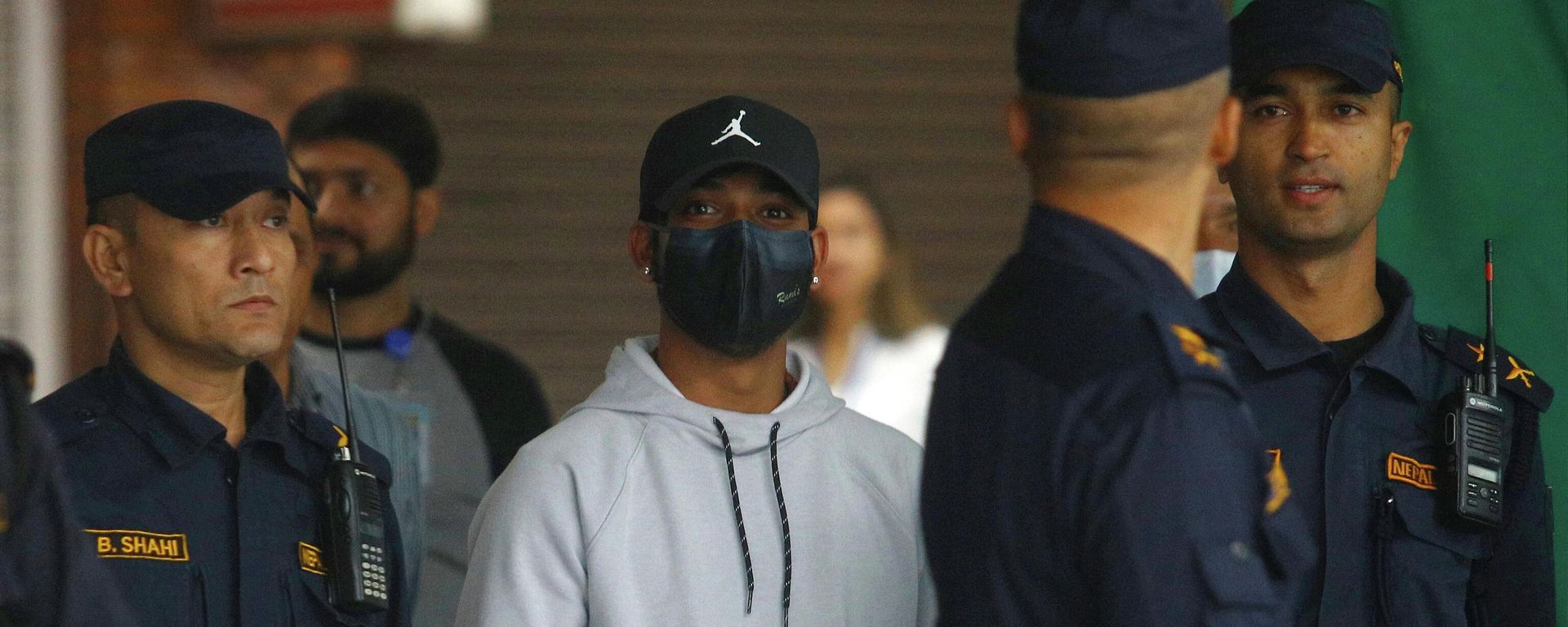 Nepali cricketer Sandeep Lamichhane (C) is escorted by police after being taken into custody to face rape charges, at Tribhuvan international airport in Kathmandu on October 6, 2022.  - Sputnik International, 1920, 06.10.2022