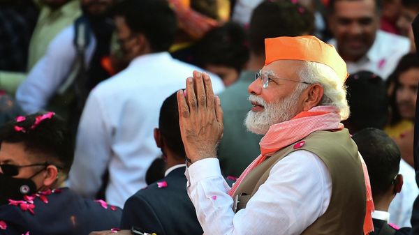 India's Prime Minister Narendra Modi gestures to supporters from a car during a road show ahead of the seventh phase of the Uttar Pradesh state assembly elections in Varanasi on March 4, 2022. - Sputnik International