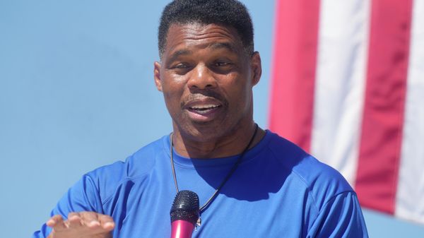 Georgia GOP Senate nominee Herschel Walker smiles during remarks during a campaign stop at Battle Lumber Co. on Thursday, Oct. 6, 2022, in Wadley, Ga. Walker's appearance was his first following reports that a woman who said Walker paid for her 2009 abortion is actually mother of one of his children - undercutting Walker's claims he didn't know who she was. - Sputnik International