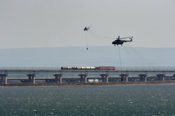 Helicopters extinguish the fire after the truck exploded on the motorway section of the Crimean Bridge. - Sputnik International