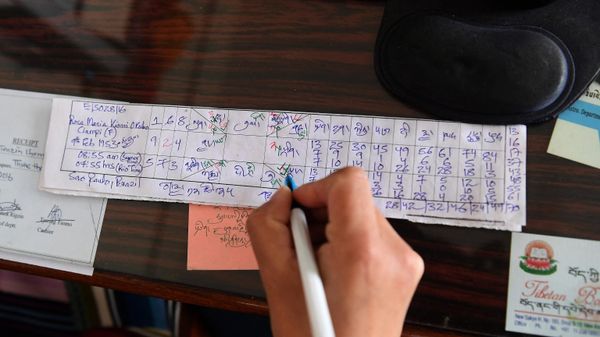 In this photograph taken on March 23, 2017, Tibetan astrologer Tenzin Tsundue writes a horoscope at the Gangkyi Men-Tsee Khang clinic in the Indian town of Dharamsala. - Sputnik International