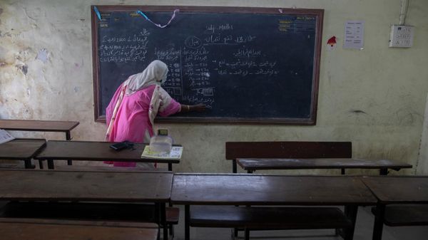 A teacher working at a government school gives an online class inside an empty class room in Dharavi, Asia's largest slum in Mumbai, India, Tuesday, Jan. 4, 2022. - Sputnik International