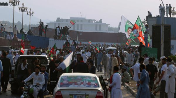 Supporters of Pakistan’s defiant former Prime Minister Imran Khan stand on shipping containers after removing them to open a road during an anti-government rally in Islamabad, Pakistan, Thursday, May 26, 2022. - Sputnik International