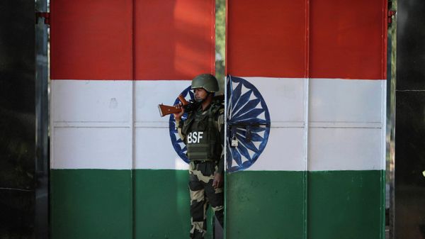 In this  Jan. 23, 2020, file photo, an Indian Border Security Force soldier walks through a gate painted with the Indian flag at the India-Pakistan border at Suchet Garh in Ranbir Singh Pura, about 27 kilometers (17 miles) south of Jammu, India. - Sputnik International