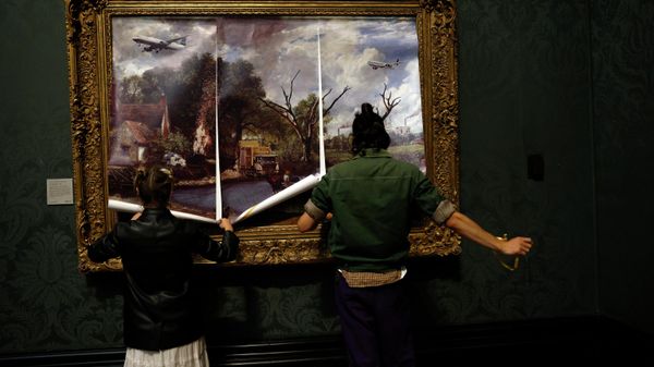 Activists from the 'Just Stop Oil' campaign group cover 'The Hay Wain' painting by English artist John Constable, in a mock 'undated' version including roads and aircraft, before glueing their hands to the frame in protest against the use of fossil fuels, in the National Gallery in London on July 4, 2022. - Sputnik International