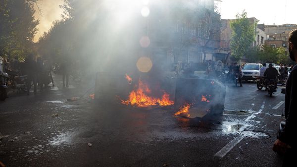 In this photo taken by an individual not employed by the Associated Press and obtained by the AP outside Iran, Iranians protests the death of 22-year-old Mahsa Amini after she was detained by the morality police last month, in Tehran, Thursday, Oct. 27, 2022. - Sputnik International