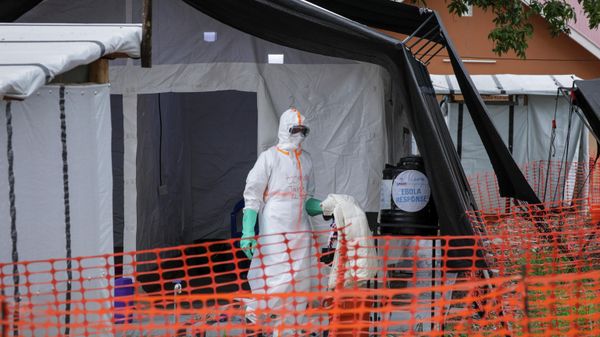 Medical workers walk inside the Ebola isolation center of Madudu Health Center III, in the village of Madudu, in the Mubende district of Uganda Tuesday, Nov. 1, 2022. - Sputnik International