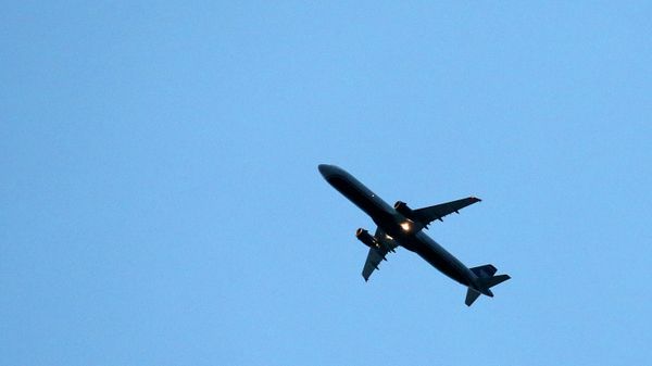 A passenger plane flies directly over a home as it brings increased noise to residential neighborhoods like this one near Phoenix as new FAA flight routes out of Phoenix Sky Harbor International Airport are affecting dozens of neighborhoods with the new noise that residents previously did not have to be subjected to Friday, Feb. 20, 2015, in Laveen, Ariz. - Sputnik International