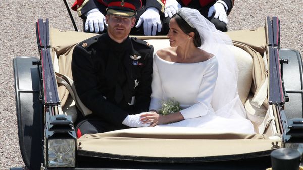 Britain's Prince Harry, Duke of Sussex and his wife Meghan,  Duchess of Sussex, are escorted by members of the Household Cavalry Mounted Regiment as they ridee in the Ascot Landau Carriage and pass through the Cambridge Gate into the grounds of Windsor Castle at the end of their carriage procession in Windsor, on May 19, 2018 after their wedding ceremony - Sputnik International