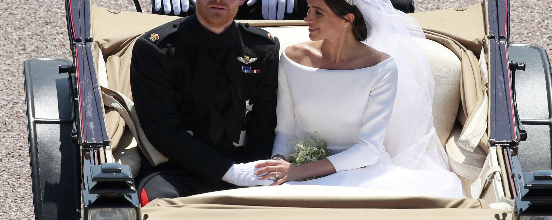 Britain's Prince Harry, Duke of Sussex and his wife Meghan, Duchess of Sussex, are escorted by members of the Household Cavalry Mounted Regiment as they ridee in the Ascot Landau Carriage and pass through the Cambridge Gate into the grounds of Windsor Castle at the end of their carriage procession in Windsor, on May 19, 2018 after their wedding ceremony Britain's Prince Harry, Duke of Sussex and his wife Meghan, Duchess of Sussex, are escorted by members of the Household Cavalry Mounted Regiment as they ridee in the Ascot Landau Carriage and pass through the Cambridge Gate into the grounds of Windsor Castle at the end of their carriage procession in Windsor, on May 19, 2018 after their wedding ceremony - Sputnik International, 1920, 08.11.2022