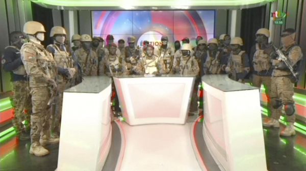 In this image from video broadcast by RTB state television, coup spokesman Capt. Kiswendsida Farouk Azaria Sorgho reads a statement in a studio in Ougadougou, Burkina Faso, on Friday evening, Sept. 30, 2022. - Sputnik International