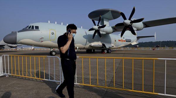 A man walks in front of a Shaanxi Aircraft Corporation's KJ-500 airborne early warning and control aircraft at the 13th China International Aviation and Aerospace Exhibition in Zhuhai in southern China's Guangdong province on September 28, 2021. - Sputnik International