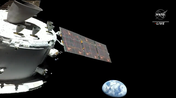 A selfie by the Orion capsule on the Artemis 1 mission showing the spacecraft and the Earth from 57,000 miles away. The photo was taken on November 16, 2022, about nine hours after liftoff. - Sputnik International