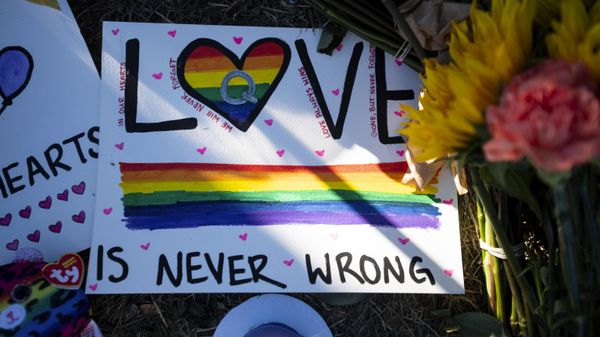 The sun shines on a sign placed at a memorial outside of Club Q on Monday, Nov. 21, 2022, in Colorado Springs, Colo. The man suspected of opening fire at the gay nightclub in Colorado Springs is being held on murder and hate crime charges. The charges surfaced in online court records Monday, two days after the attack that killed at least five people and wounded many others. - Sputnik International